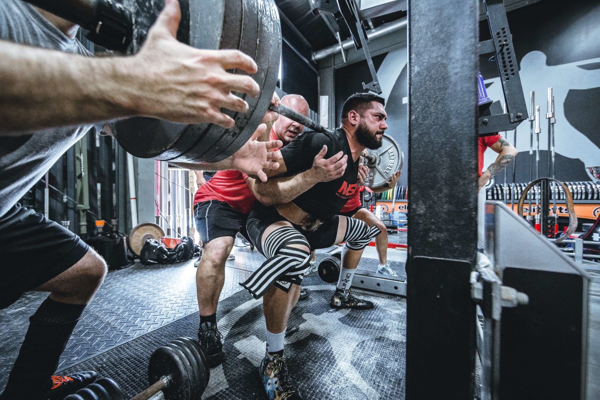 Heavy squatting with spotter